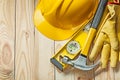 Claw hammer construction level leather gloves and construction helmet on wood Royalty Free Stock Photo