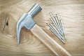 Claw hammer construction nails on wooden board top view building Royalty Free Stock Photo