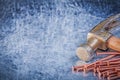 Claw hammer copper construction nails on metallic background Royalty Free Stock Photo