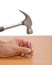 Claw hammer and hand with nail Royalty Free Stock Photo