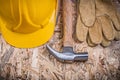 Claw hammer hard hat leather gloves on chipboard construction co Royalty Free Stock Photo