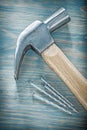 Claw hammer stainless nails on wooden board top view constructio Royalty Free Stock Photo