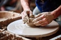 Clay artist forming jar from wet clay piece in workshop. Closeup man hands sculpting in pottery