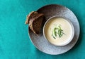 Clay bowl of Finnish salmon cream soup served with leek and croutons on green tablecloth background. Food background Royalty Free Stock Photo
