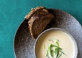 Clay bowl of Finnish salmon cream soup served with leek and croutons on green tablecloth background. Food background Royalty Free Stock Photo