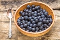 Clay bowl with fresh wild berries on wooden background Royalty Free Stock Photo