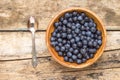 Clay bowl with fresh wild berries on wooden background Royalty Free Stock Photo