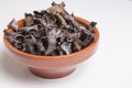 Clay bowl full of Horn of Plenty mushrooms Royalty Free Stock Photo