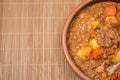 Clay bowl with homemade lentil stew, tomato, Spanish chorizo, meat and potatoes Royalty Free Stock Photo