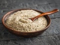 Clay bowl with a spoon filled with salt with herbs on the dark rustic wooden table. Royalty Free Stock Photo