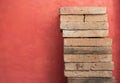 Clay brick stack over red cement wall background Royalty Free Stock Photo