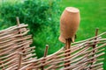 Clay broken pitcher hang wooden rural woven fence