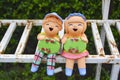 Clay child dolls holding sign board after raining