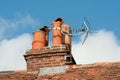 Clay chimney pots on old tiled roof Royalty Free Stock Photo