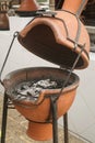 Clay device for cooking on coals and barbecue