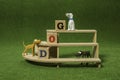 Clay dog on the shelf with wooden alphabet cube