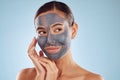Clay face mask, skincare and woman with beauty in studio isolated on blue background. Cosmetics, model and natural