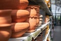 Clay flower pots on a store shelf. Defocus background perspective, flower pot made of natural unpainted clay, vases and handmade