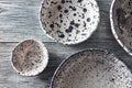 Clay handcraft empty bowls, plates, covered with glazed , place under text on a gray wooden background. Flat lay Royalty Free Stock Photo