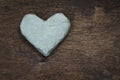 Clay heart on wooden surface