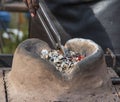 Clay hearth with hot coals for heating metal