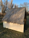 Clay house with a thatched roof, in the countryside. Royalty Free Stock Photo