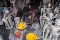 The clay idol maker preparing colors for idols.