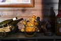 Clay jugs of wine on a wooden shelf in the sunset Royalty Free Stock Photo