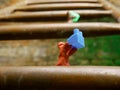 Clay man holding building block on hand climbing on iron metal stairs