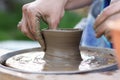 Clay modeling, creation of a clay pot on a manual Potter`s wheel Royalty Free Stock Photo