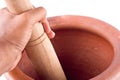 Clay mortar and wood pestle is used to mix the ingredient with male hand on white background cooking kitchenware object Royalty Free Stock Photo