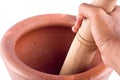 Clay mortar and wood pestle is used to mix the ingredient with male hand on white background cooking kitchenware object isolated Royalty Free Stock Photo