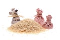 The clay mouse with bags and a heap of rice