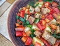 Clay plate with mix colourful vegetable soup or stew and crackers top view