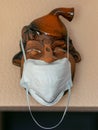 Clay portrait with a medical face mask, protection against covid-19 virus