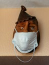 Clay portrait with a medical face mask, protection against covid-19 virus