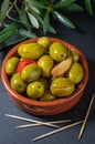 Clay pot with artisan olives preserved in extra virgin olive oil, vinegar, spices with red peppers and garlic. Royalty Free Stock Photo