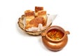 Clay pot of beef goulash soup with tongue served with a slice of bread