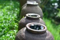 Clay pot filled with water, placed outdoors.