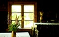 Clay pot and flower bouquet at the table near the window. Vintage retro still life photo. Village house interior concept