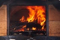 Clay pot and frying pan with meat stands in a Russian oven on an open fire on wood, stewed roast. Rustic authentic food.