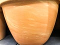 Clay pot for growing plants, flowers. earth is poured into a pot of heterogeneous texture. texture with stains of orange color