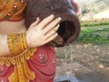 Clay pot in the hand of a female idol