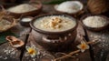 Clay pot with Kiribath on a rustic table, surrounded by coconut milk, rice, and frangipani flowers for Sinhalese New