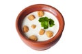 Clay pot with milk soup croutons Royalty Free Stock Photo