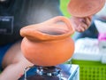 Clay pot with smoke. Cooking process on tourist camp.