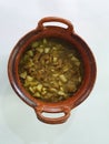 Clay pots filled with pork rinds in green sauce