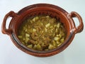 Clay pots filled with pork rinds in green sauce