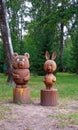 Clay pots in garden. wooden figures in the garden. Winnie the Pooh and Piglet.