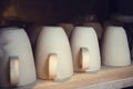 Clay pottery ceramic mugs products dry on shelf in workshop